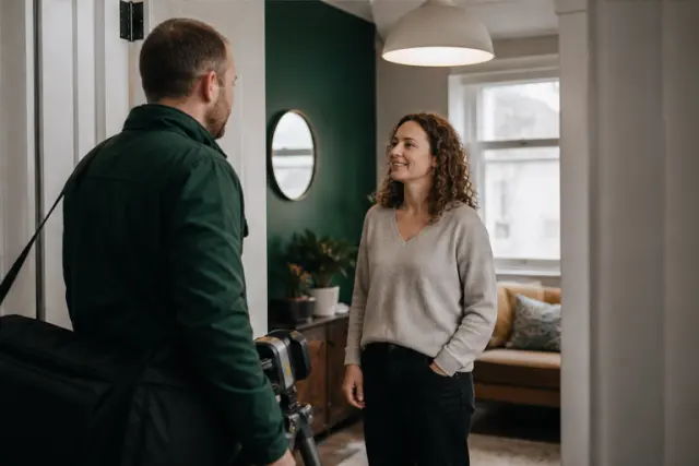 Private tenant welcoming an energy assessor into a British flat