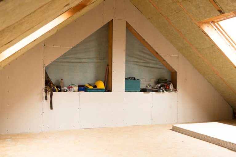 house attic under construction mansard wall insulation with rock wool